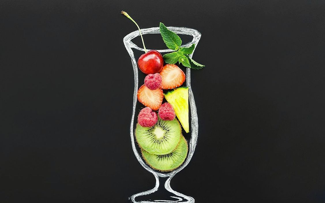 A tall glass of bright green fresh-pressed juice