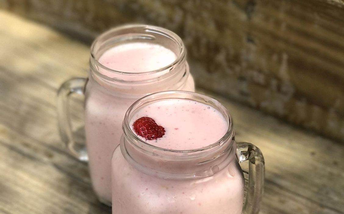A tropical fruit smoothie garnished with pineapple
